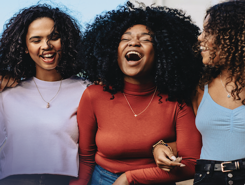 Three young women laughing