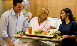 New mom and dad speaking with maternity staff person