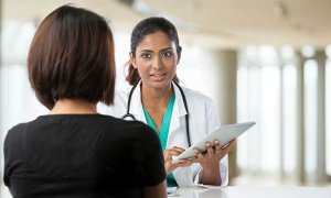 Doctor discussing something with a patient.