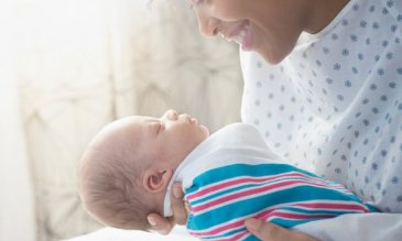 A mother holding her newborn baby