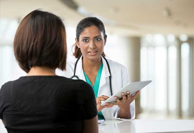 Doctor discussing something with a patient.