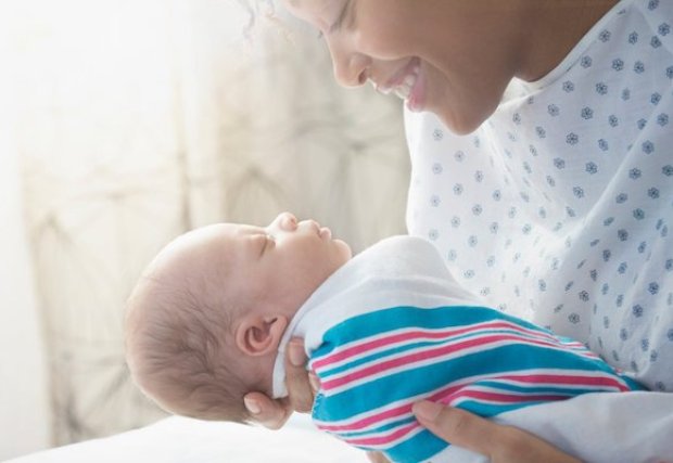 A mother holding her newborn baby